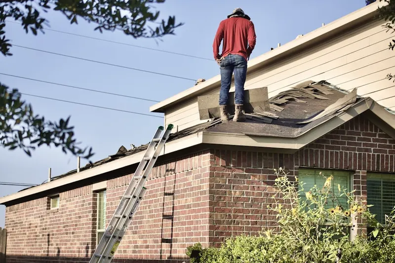 Professional roofer working on a residential roof in Iowa City